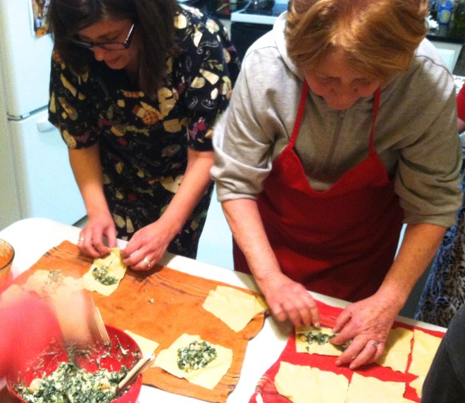 great cooks in my kitchen rolling up the cannelloni
